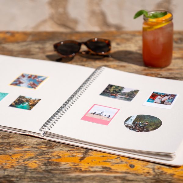 An open photo book with printed pictures on a table